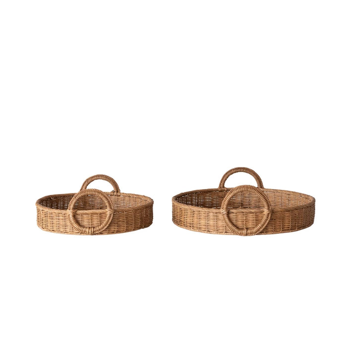 Two woven baskets with circular handles on a white background