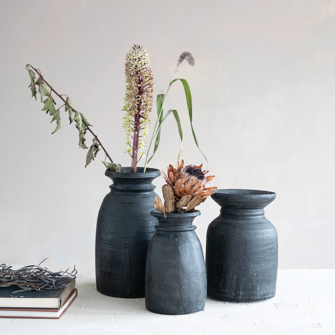 black wood vases with greenery and florals