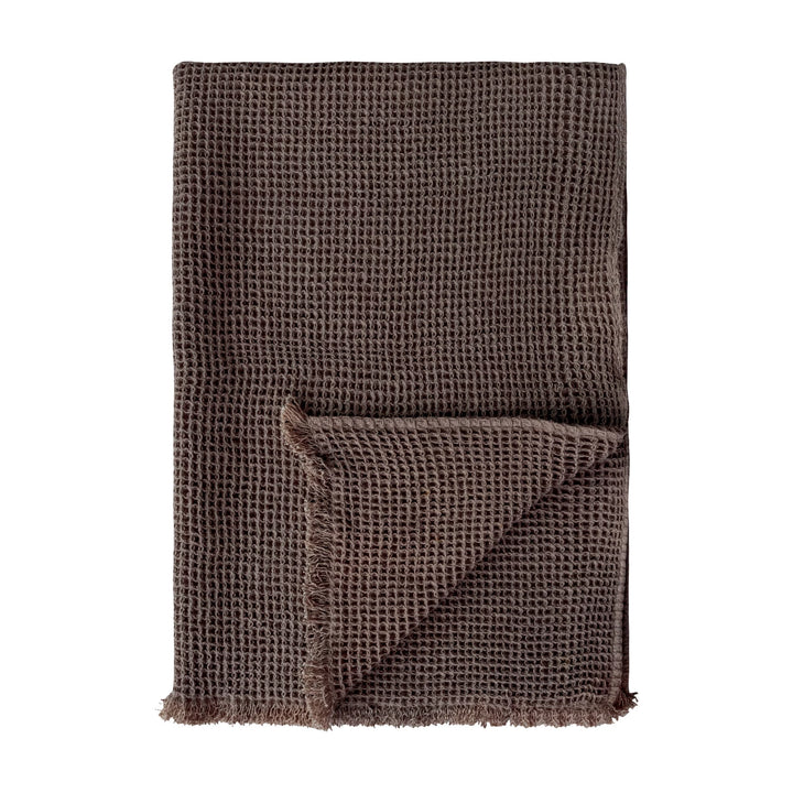 Brown textured blanket on a white background
