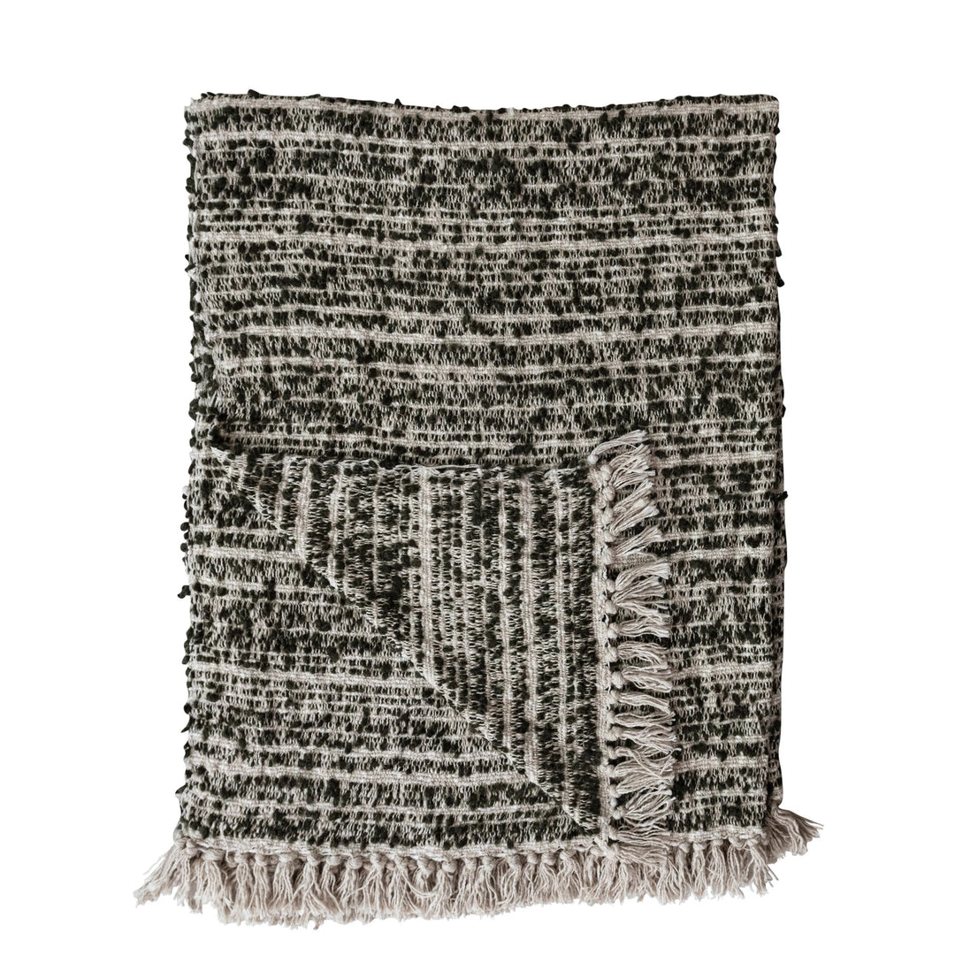 Textured throw blanket with fringe on a white background