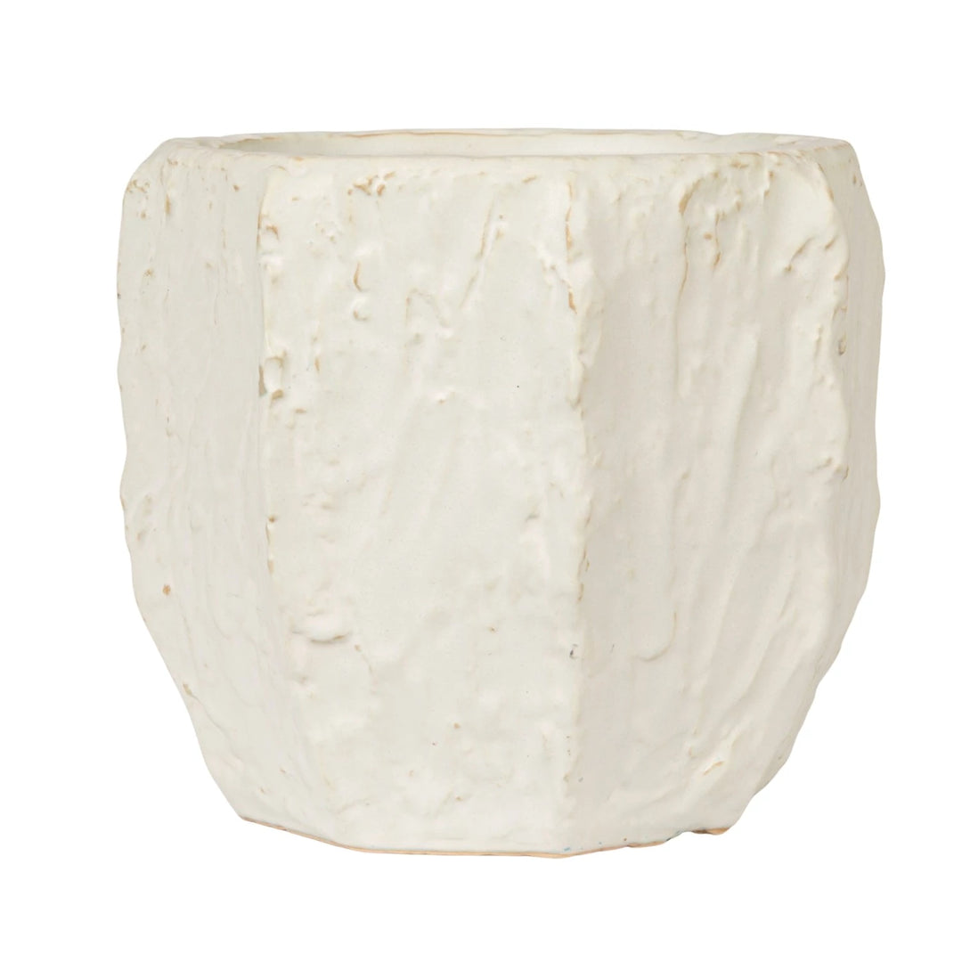White ceramic planter with textured surface on a white background