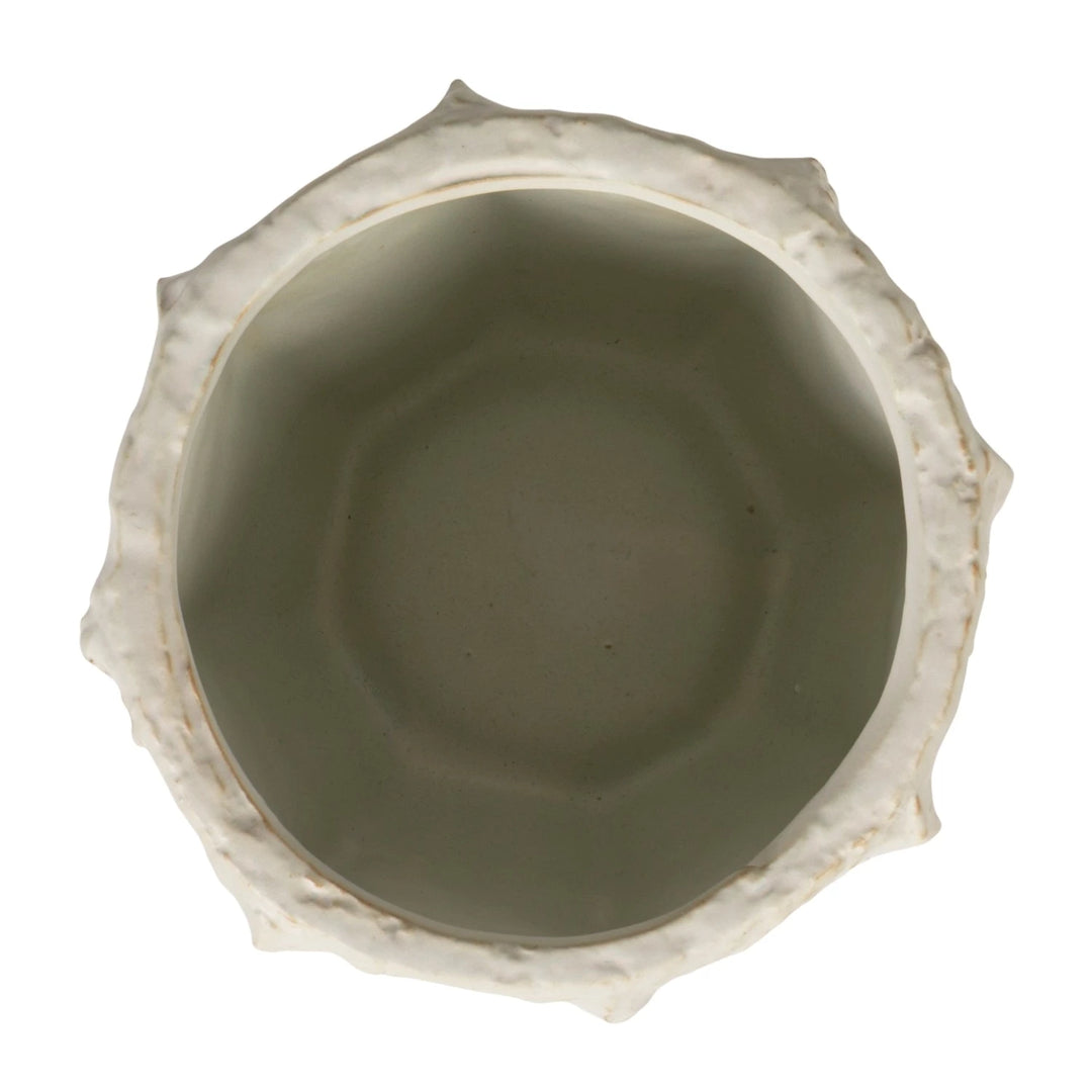Ceramic bowl with textured rim on a white background