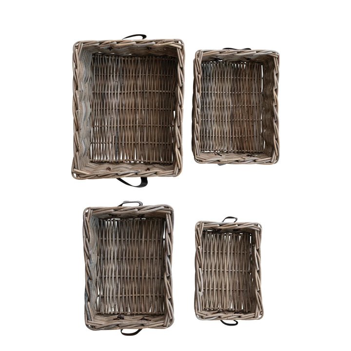 Set of four wicker baskets of different sizes on a white background