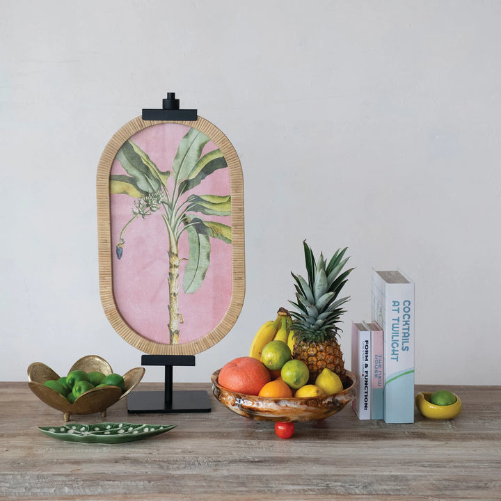 Decorative setup with a framed botanical print on easel