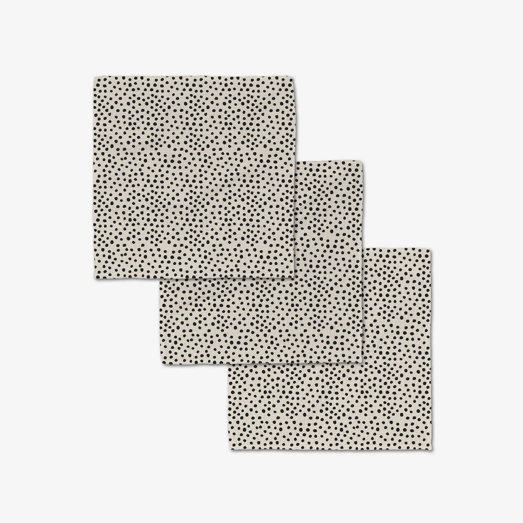 Three black and tan patterned dish cloth on a light gray background