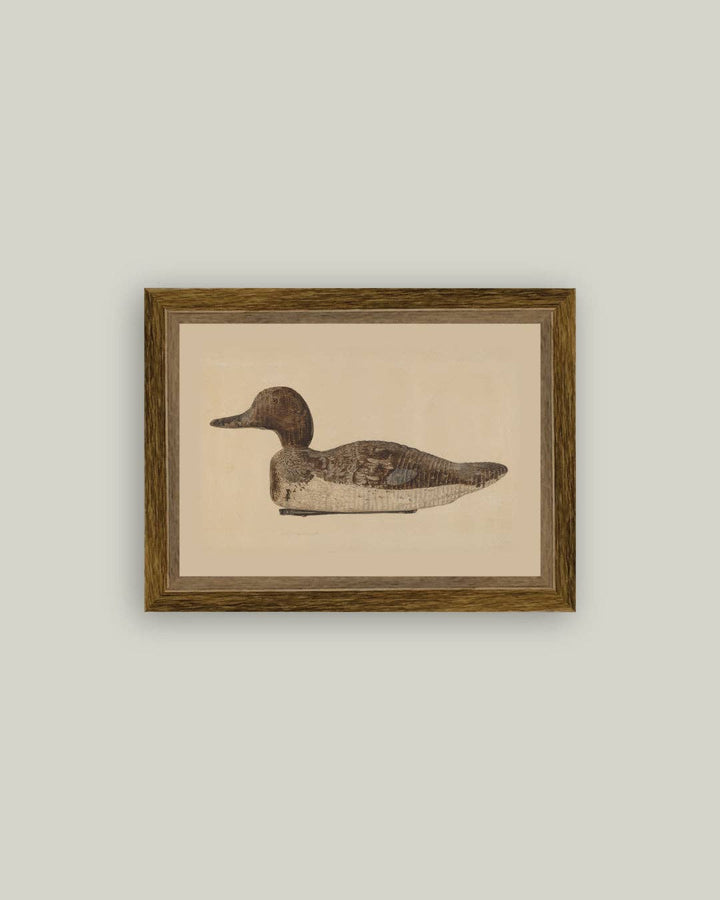 Framed artwork of a duck decoy with a beige background