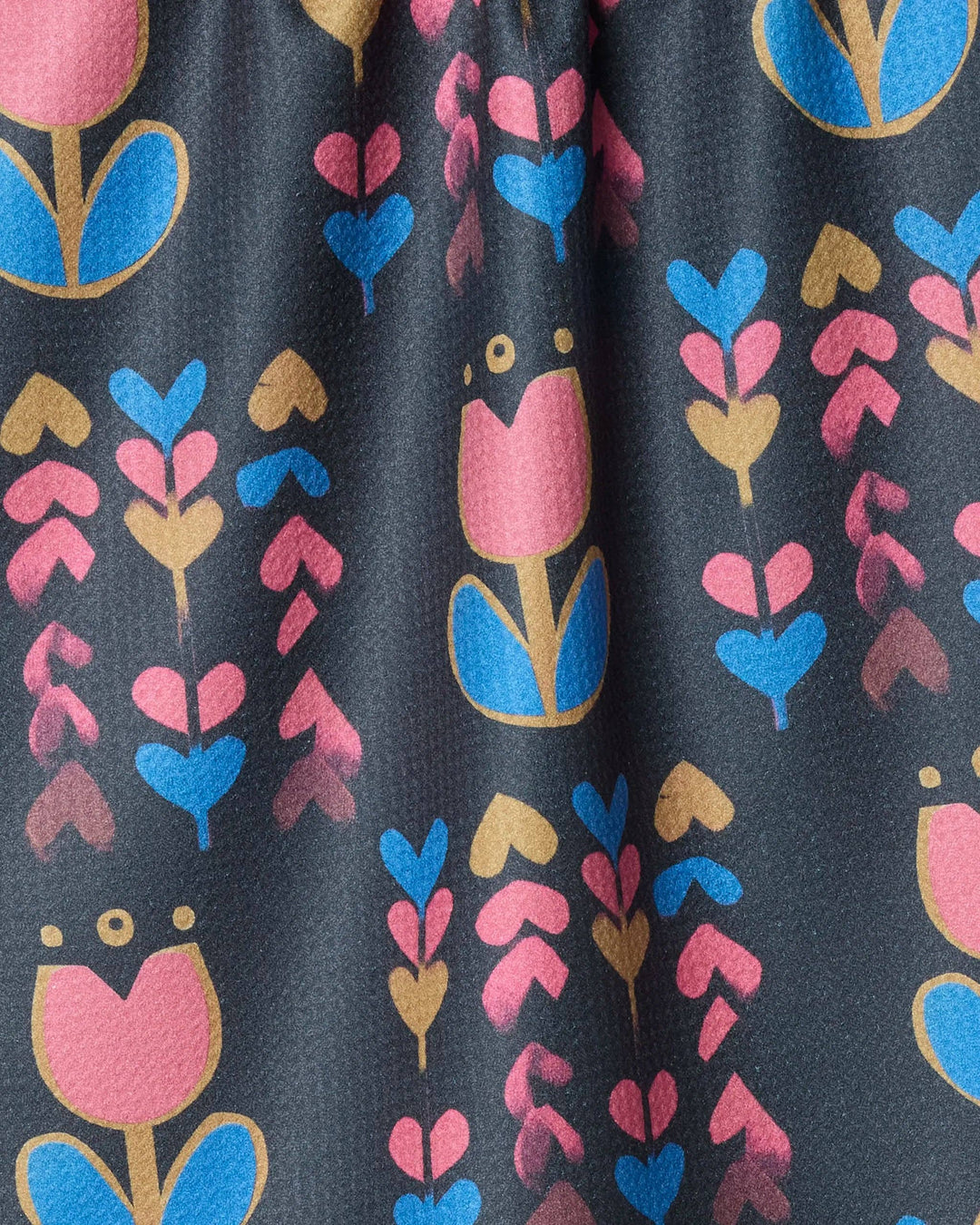 Close-up of fabric with colorful floral pattern on a dark background