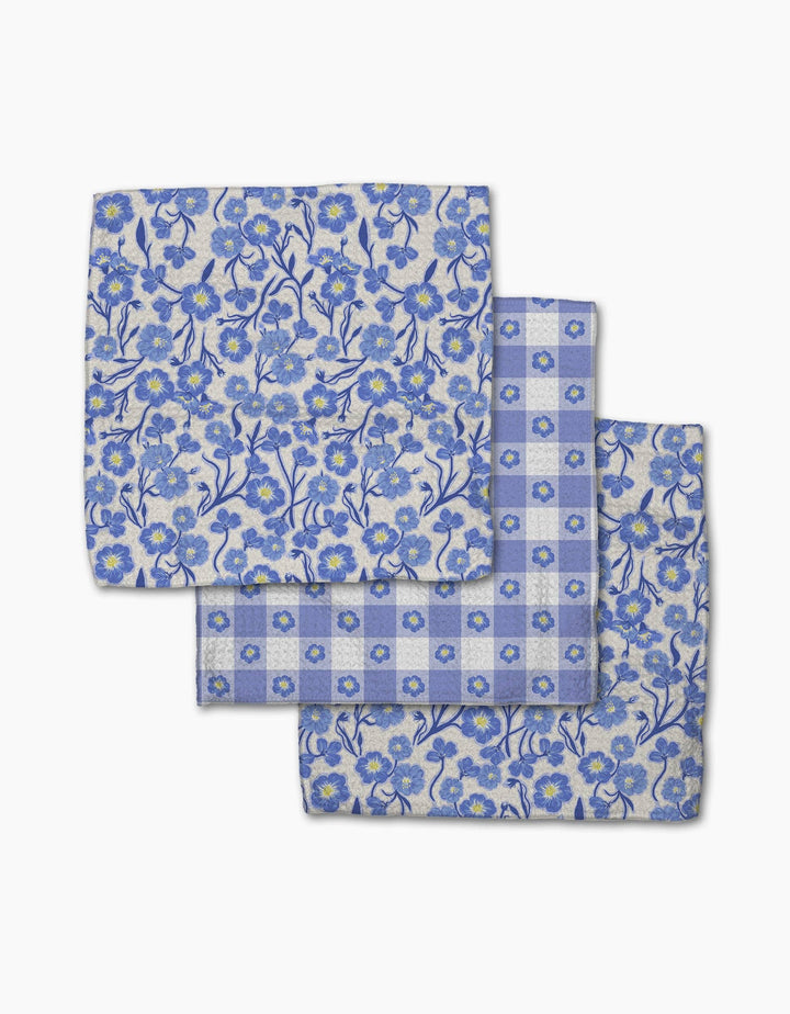 Set of three blue floral and checkered patterned cloths on a white background