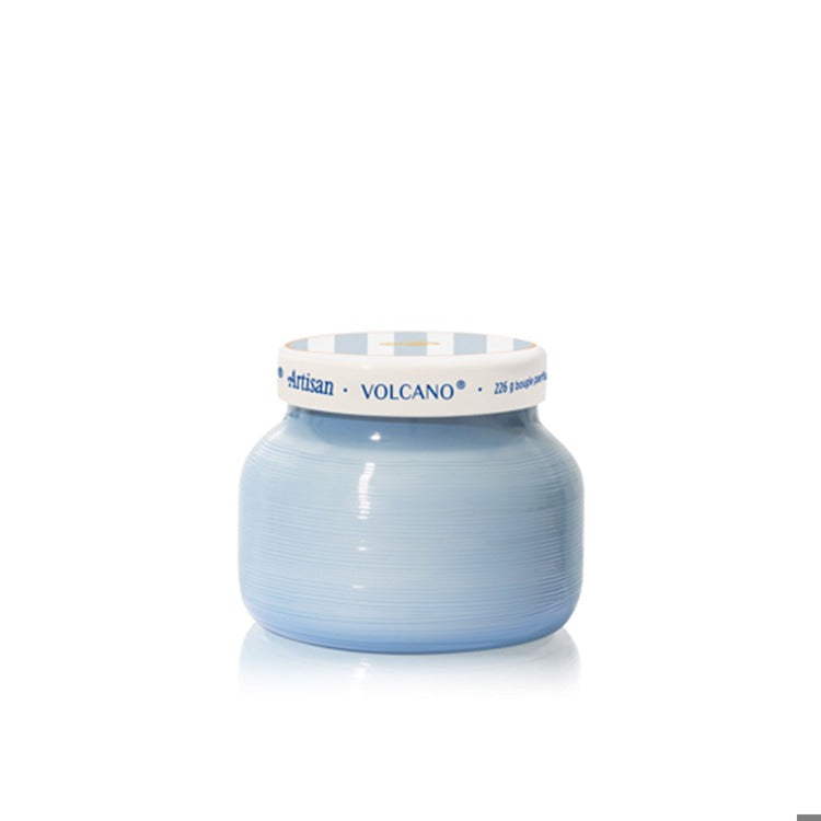 Blue candle with a white lid on a white background