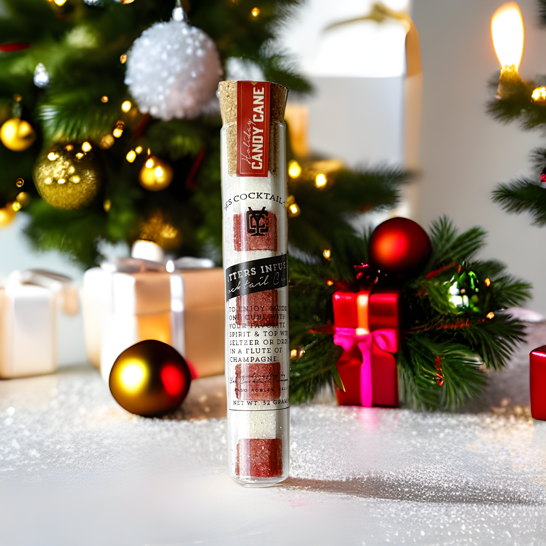 Cocktail mix tube with candy cane flavor in front of a festive Christmas background