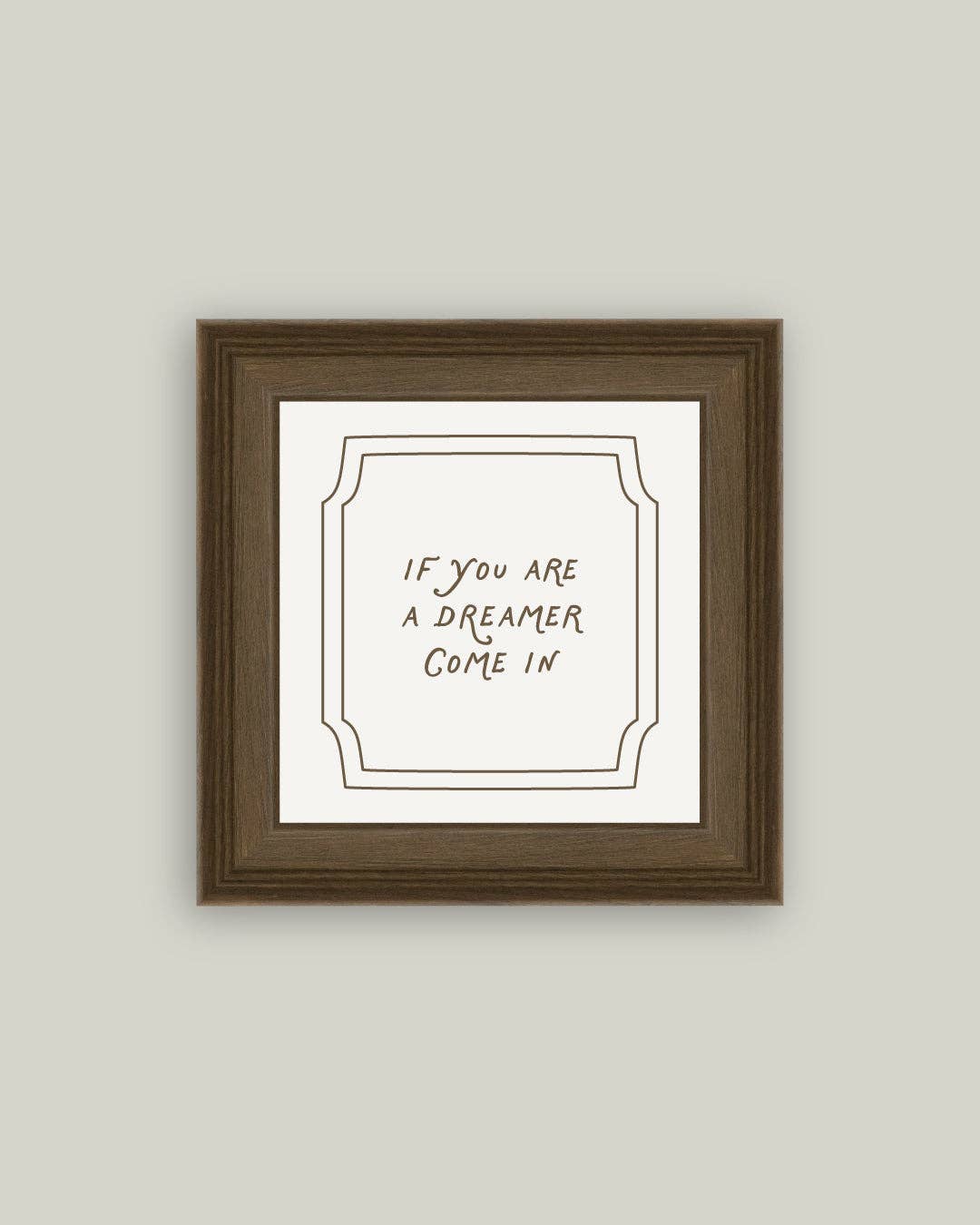 Framed print with text 'If you are a dreamer come in' on a plain background