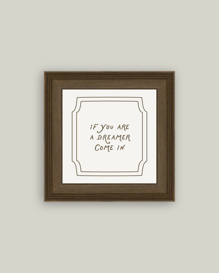 Framed print with text 'If you are a dreamer come in' on a plain background