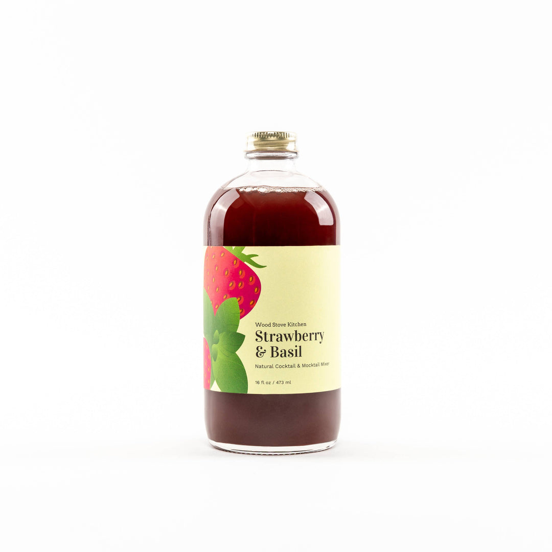 Bottle of strawberry and basil-flavored liquid on a white background