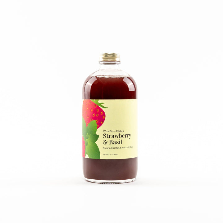 Bottle of strawberry and basil-flavored liquid on a white background