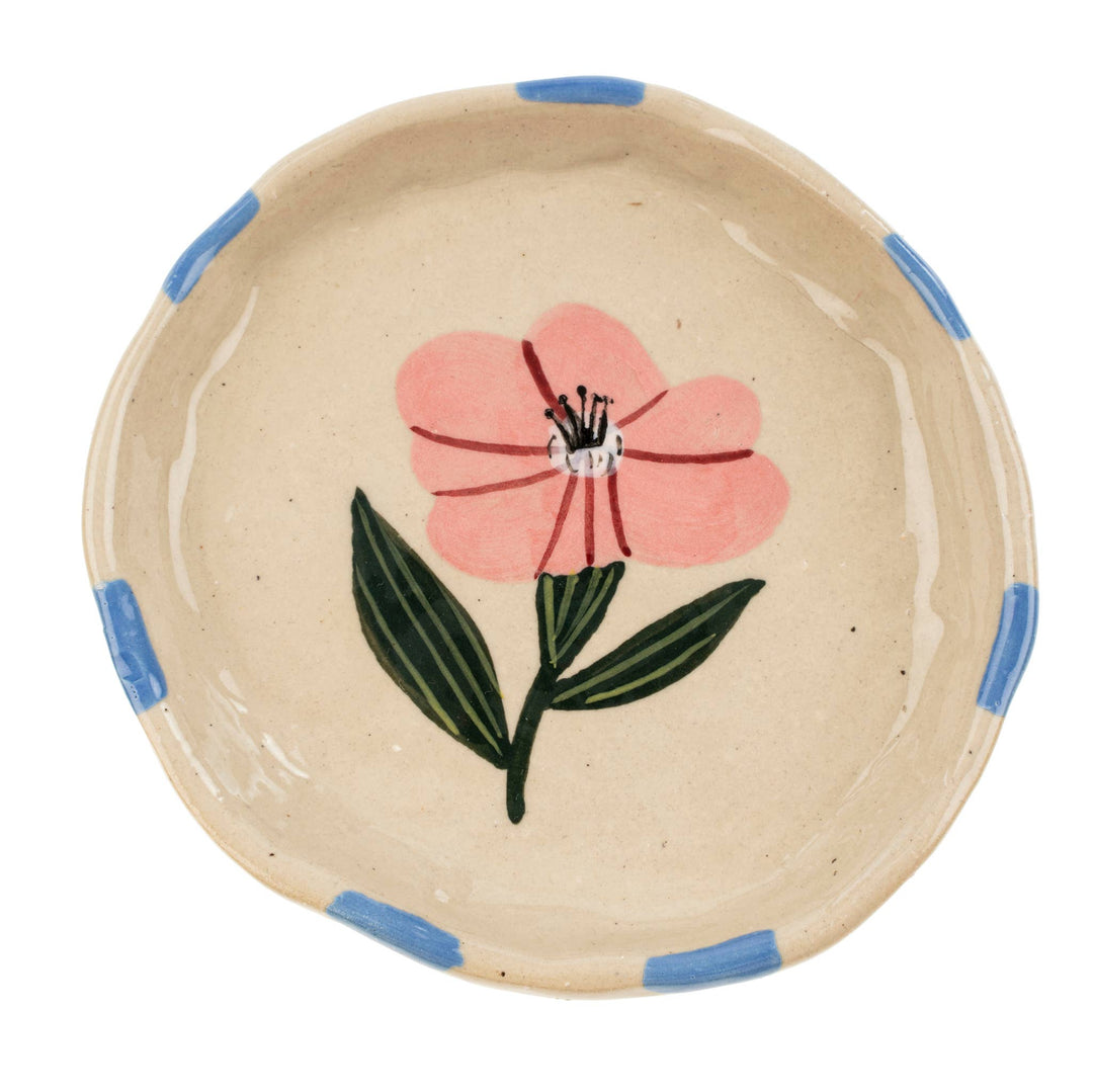 beige ceramic plate with a pink flower design and blue accents