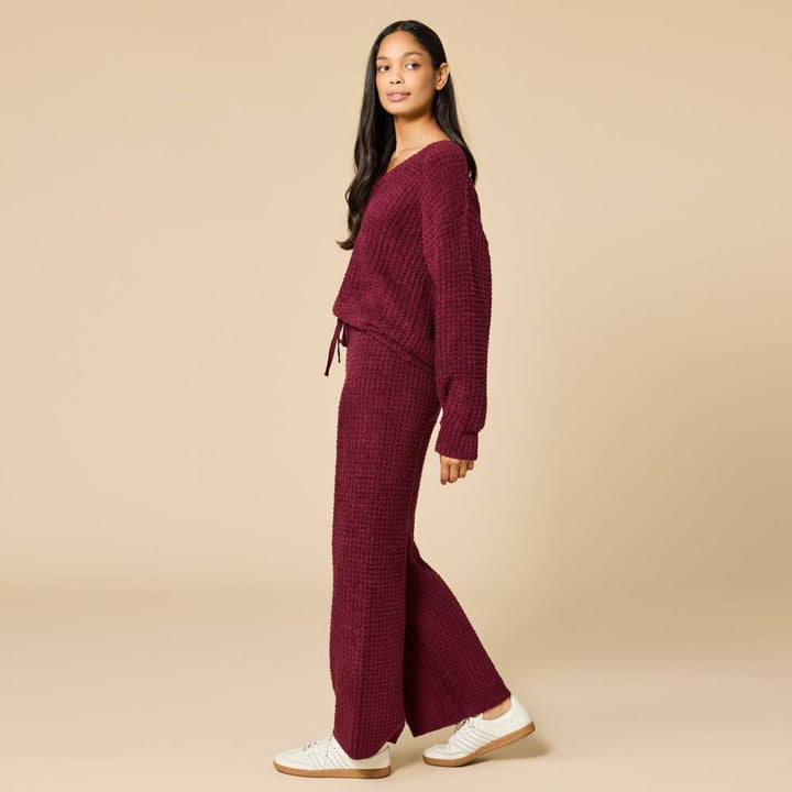 Woman wearing a burgundy cherry cola colored marshmellow waffle pajama set