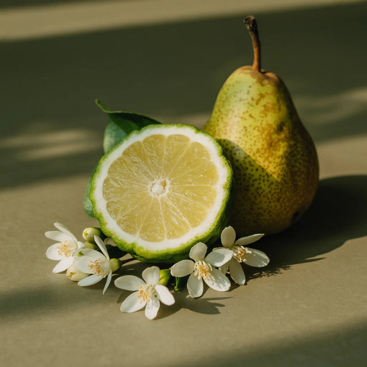 Pear, lime, and white flowers on a green background