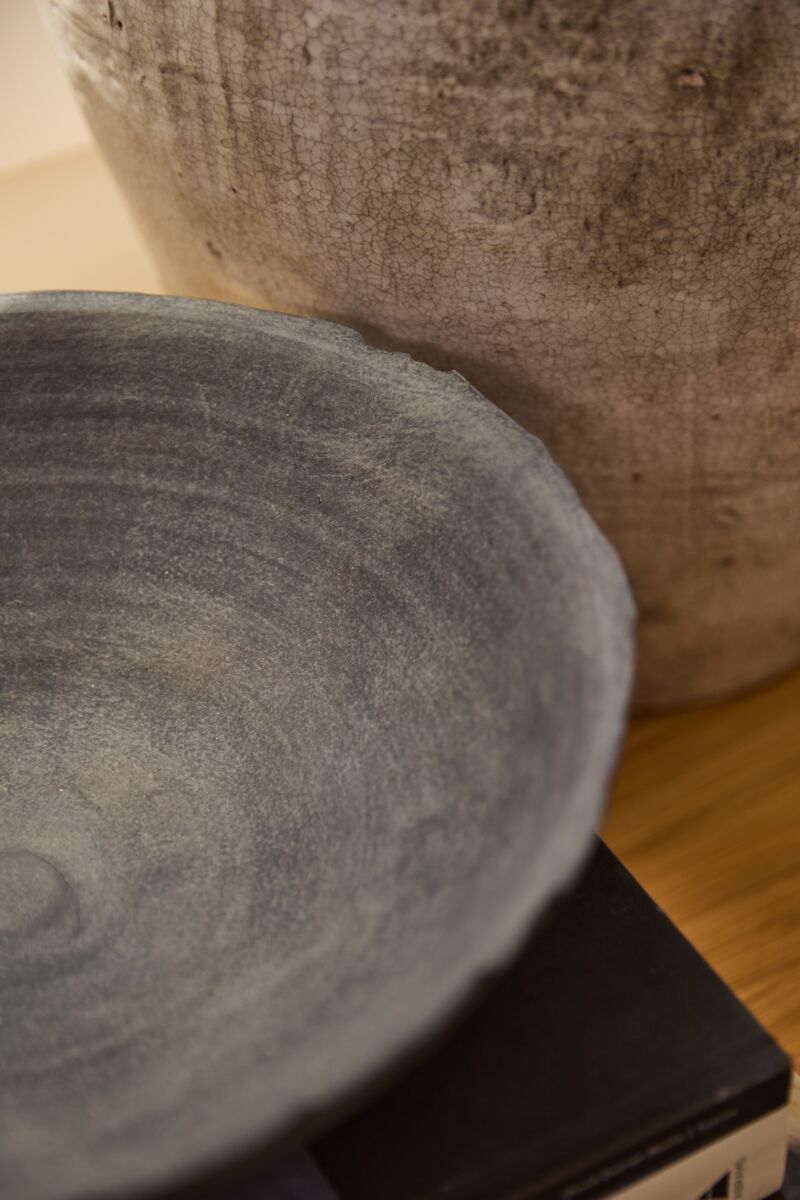 Two handcrafted terracotta bowls with matte black finish, one large and one small, displayed side by side.