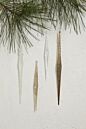  elongated diamond shaped glass icicle ornaments with a slightly iridescent finish, hanging from metallic strings.