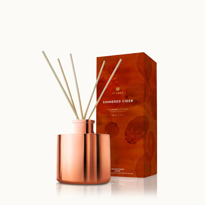 Copper diffuser with wooden sticks and orange packaging 