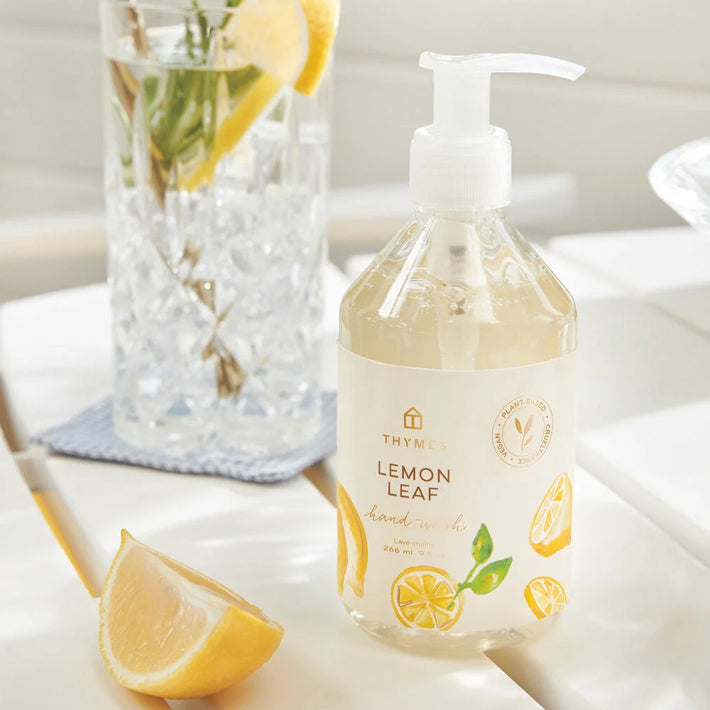 Lemon leaf hand wash bottle on a bathroom counter with lemons 