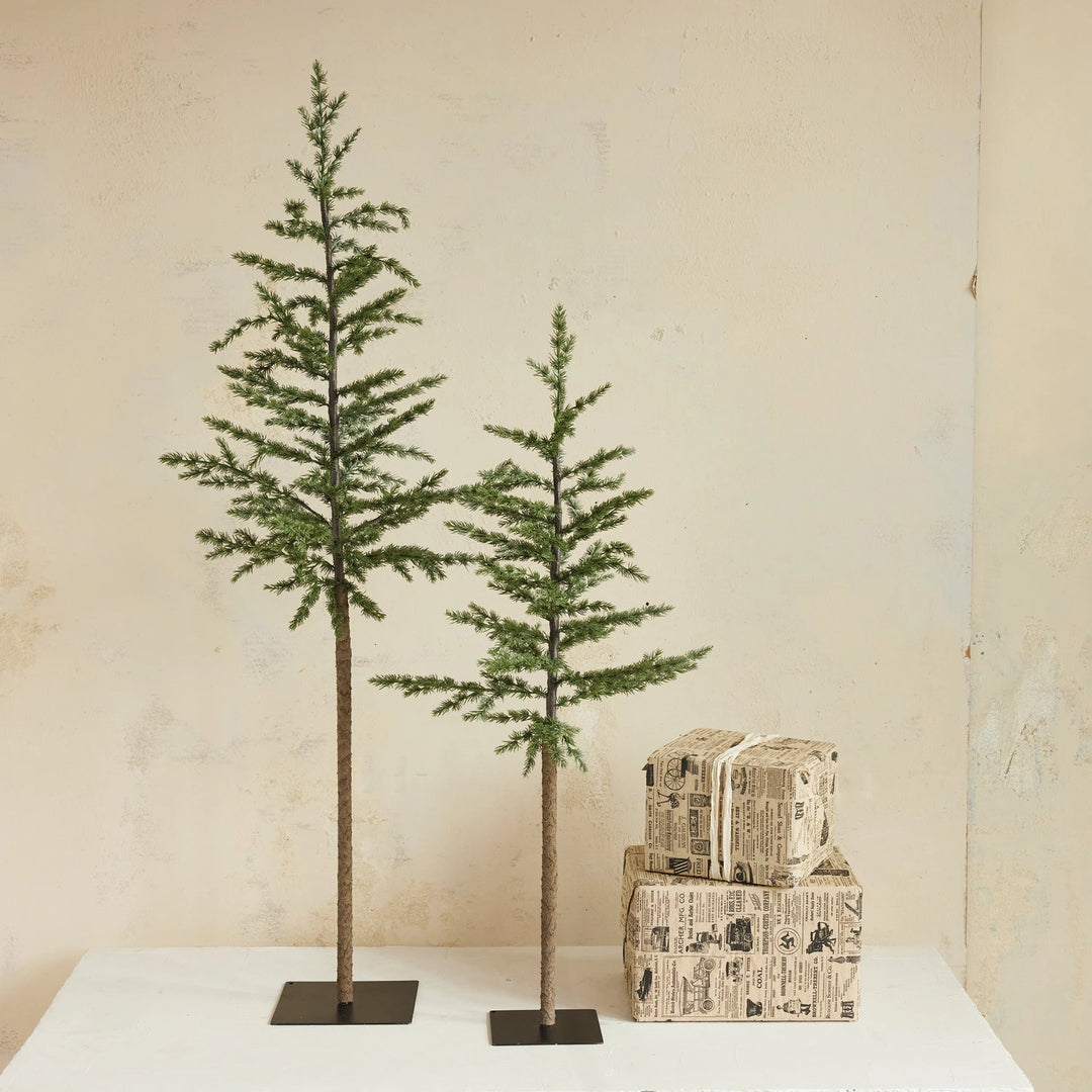 Two faux pine trees with metal bases  one larger one smaller
